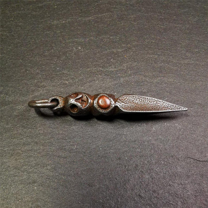 This phurba was made by Tibetan craftsmen and come from Hepo Town, Baiyu County,Tibet. Its upper part is Shmashana Adhipati skull, the lower part is a Dorje Phurba,and a copper dot inlaid on the waist of the phurba