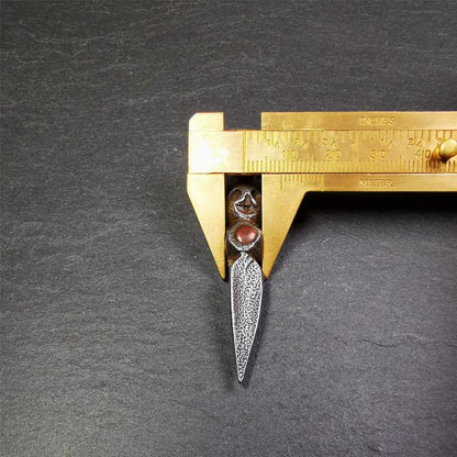 This phurba was made by Tibetan craftsmen and come from Hepo Town, Baiyu County,Tibet. Its upper part is Shmashana Adhipati skull, the lower part is a Dorje Phurba,and a copper dot inlaid on the waist of the phurba