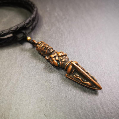 This vintage Phurba pendant was collected from Rega Monastery(Baiyu,Tibet),handmade of copper. It has a statue of Vajrapani on the top and a phurba on the lower part, measuring about 2.36 inches by 0.47 inch.