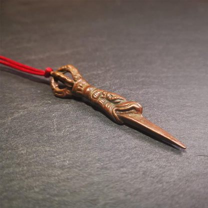 This vintage Phurba pendant was collected from gengqing Monastery(Derge,Tibet),handmade of copper. It is total 2.6 inches,brown color,on top of it is a dragon, the tail of the dragon is half vajra, from the dragon's mouth comes a phurba.