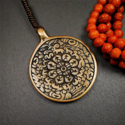This unique meling amulet is handmade in Baiyu County Tibet,Where is the famous handicraft industry base in Tibetan areas.  It is made of lima brass,2.16 inches diameter,the front center is a very rare mandala flower shape.