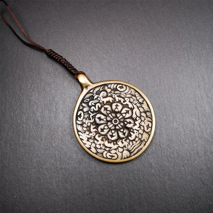 This unique meling amulet is handmade in Baiyu County Tibet,Where is the famous handicraft industry base in Tibetan areas.  It is made of lima brass,2.16 inches diameter,the front center is a very rare mandala flower shape.