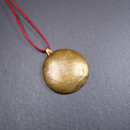 This Longevity Badge was handmade by Tibetan craftsmen and come from Hepo Town, Baiyu County, Tibet. It is made of brass,round shape,the theme is the god of longevity,surrounded by the symbols of Ashtamangala.