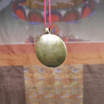 This Longevity Badge was handmade by Tibetan craftsmen and come from Hepo Town, Baiyu County, Tibet. It is made of brass,round shape,the theme is the god of longevity,surrounded by the symbols of Ashtamangala.