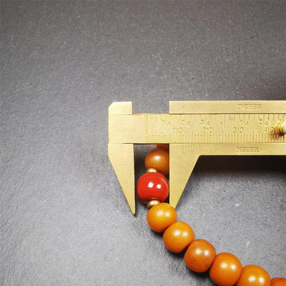 This mala was made by Tibetan craftsmen.  It is made of Corypha Linn Seeds, diameter of 10mm / 0.4",circumference is 22cm / 8.7" ,with agate spacer bead, end of a white copper guru bead.