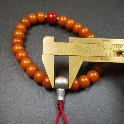 This mala was made by Tibetan craftsmen.  It is made of Corypha Linn Seeds, diameter of 10mm / 0.4",circumference is 22cm / 8.7" ,with agate spacer bead, end of a white copper guru bead.