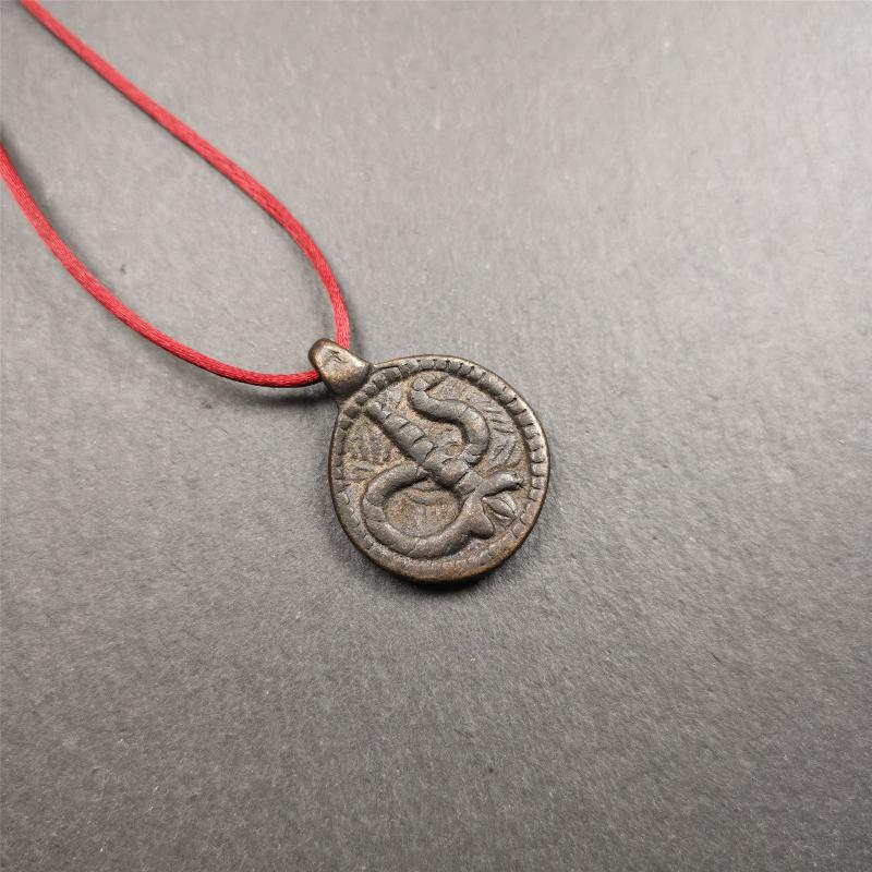 These amulet were  handmade by Tibetan craftsmen from Tibet in 1990's. It's made of copper/brass,brown/yellow color,diameter is 0.83 inch,comes with a leather cord. You can make it into a necklace,or bag hanging
