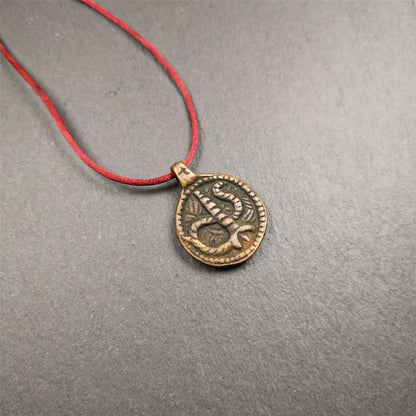 These amulet were  handmade by Tibetan craftsmen from Tibet in 1990's. It's made of copper/brass,brown/yellow color,diameter is 0.83 inch,comes with a leather cord. You can make it into a necklace,or bag hanging