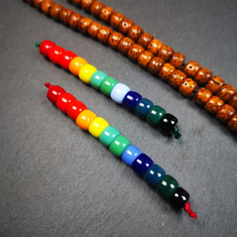 The price is 1 pair of 2 Strings Sherpa Glaze Beads,total 24 beads.(each string 12 beads)  These marker beads were handmade by Tibetan craftsmen and come from Hepo Town, Baiyu County, the birthplace of the famous Tibetan handicrafts. It is made of sherpa glaze,rainbow color,size is 0.31" × 0.24". Fit for 6-8mm mala (The reference in the photo is 8mm lotus seed mala)