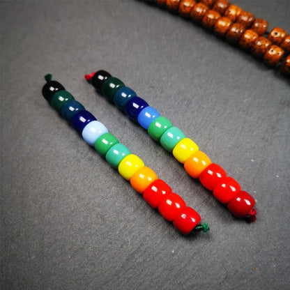 The price is 1 pair of 2 Strings Sherpa Glaze Beads,total 24 beads.(each string 12 beads)  These marker beads were handmade by Tibetan craftsmen and come from Hepo Town, Baiyu County, the birthplace of the famous Tibetan handicrafts. It is made of sherpa glaze,rainbow color,size is 0.31" × 0.24". Fit for 6-8mm mala (The reference in the photo is 8mm lotus seed mala)