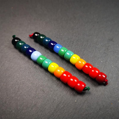 The price is 1 pair of 2 Strings Sherpa Glaze Beads,total 24 beads.(each string 12 beads)  These marker beads were handmade by Tibetan craftsmen and come from Hepo Town, Baiyu County, the birthplace of the famous Tibetan handicrafts. It is made of sherpa glaze,rainbow color,size is 0.31" × 0.24". Fit for 6-8mm mala (The reference in the photo is 8mm lotus seed mala)
