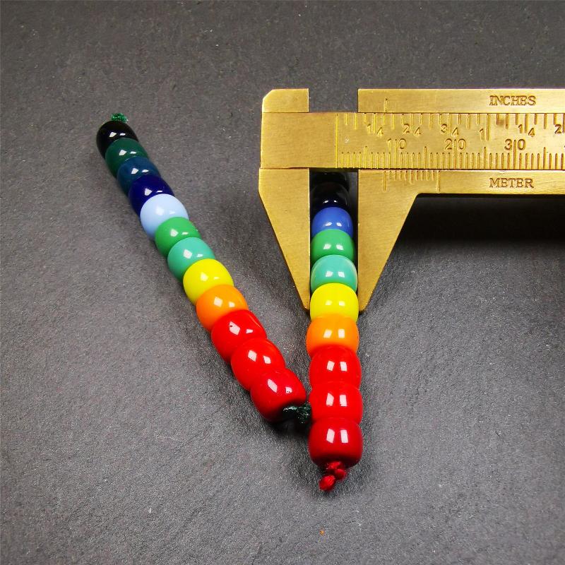 The price is 1 pair of 2 Strings Sherpa Glaze Beads,total 24 beads.(each string 12 beads)  These marker beads were handmade by Tibetan craftsmen and come from Hepo Town, Baiyu County, the birthplace of the famous Tibetan handicrafts. It is made of sherpa glaze,rainbow color,size is 0.31" × 0.24". Fit for 6-8mm mala (The reference in the photo is 8mm lotus seed mala)