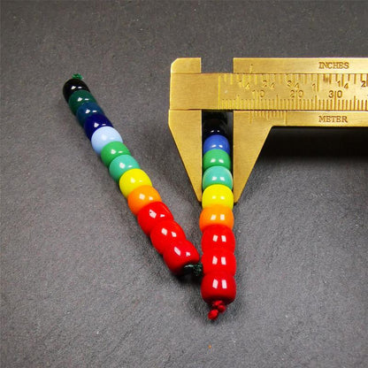 The price is 1 pair of 2 Strings Sherpa Glaze Beads,total 24 beads.(each string 12 beads)  These marker beads were handmade by Tibetan craftsmen and come from Hepo Town, Baiyu County, the birthplace of the famous Tibetan handicrafts. It is made of sherpa glaze,rainbow color,size is 0.31" × 0.24". Fit for 6-8mm mala (The reference in the photo is 8mm lotus seed mala)