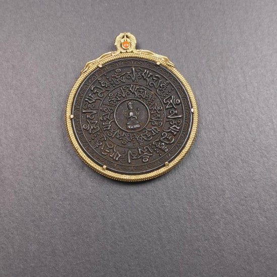 This badge was made by Tibetan craftsmen and come from Hepo Town, Baiyu County,Tibet. It is made of thokcha, edging with copper, 2.1 diameter. The mantra Om Mani Padme Hum is arranged in concentric circles around the chenrezig.