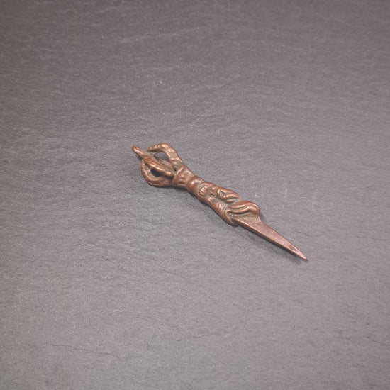 This vintage Phurba pendant was collected from gengqing Monastery(Derge,Tibet),handmade of copper. It is total 2.6 inches,brown color,on top of it is a dragon, the tail of the dragon is half vajra, from the dragon's mouth comes a phurba.